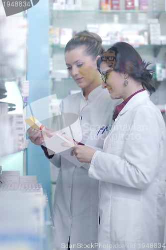 Image of team of pharmacist chemist woman  in pharmacy drugstore