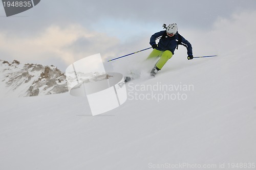 Image of skiing on fresh snow at winter season at beautiful sunny day