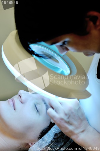 Image of woman with facial mask in cosmetic studio