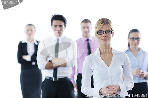 Image of business woman standing with her staff in background