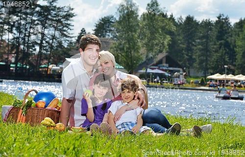 Image of Happy family playing together in a picnic outdoors