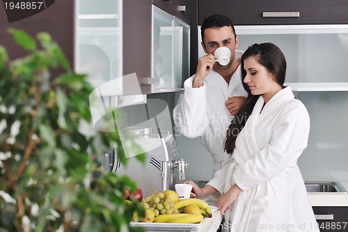 Image of Young love couple taking fresh morning cup of coffee