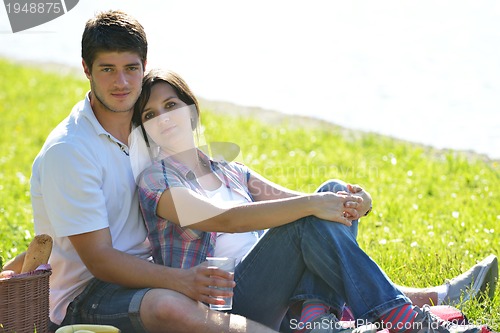 Image of happy young couple having a picnic outdoor
