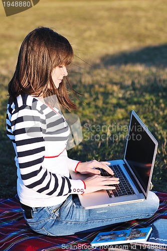 Image of young teen girl work on laptop outdoor
