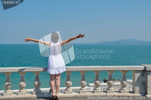 Image of happy young woman with spreading arms to sky