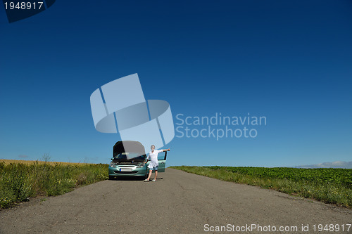 Image of woman with broken car