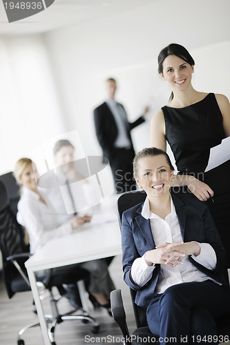 Image of business woman with her staff in background