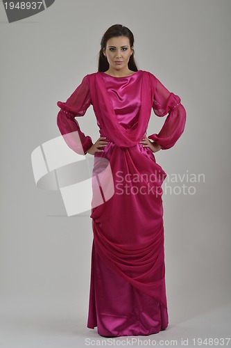 Image of elegant woman in fashionable dress posing in the studio
