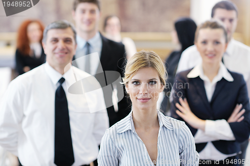 Image of business woman standing with her staff at conference