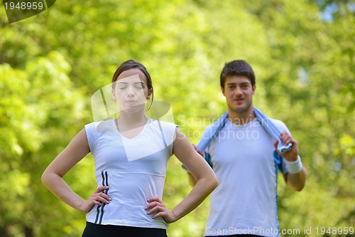 Image of Couple doing stretching exercise  after jogging