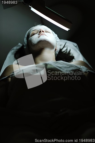 Image of woman with facial mask in cosmetic studio