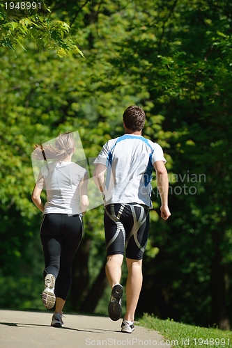 Image of Young couple jogging at morning