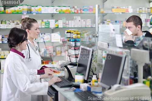 Image of pharmacist suggesting medical drug to buyer in pharmacy drugstor