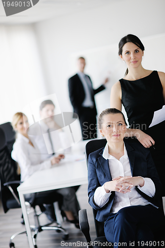 Image of business woman with her staff in background