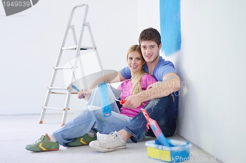 Image of happy young cople relaxing after painting in new home