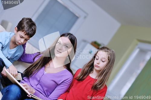 Image of young mom play with their kids at home and reading book