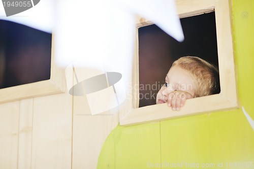 Image of happy child in a window