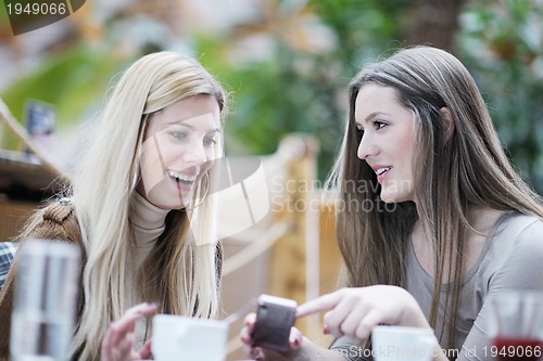 Image of cute smiling women drinking a coffee