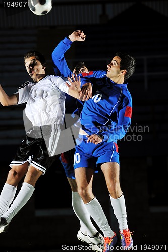 Image of football players in action for the ball