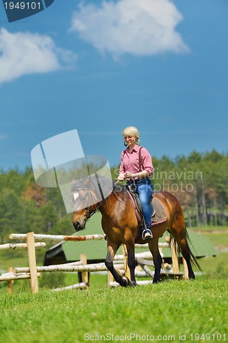 Image of happy woman  on  horse