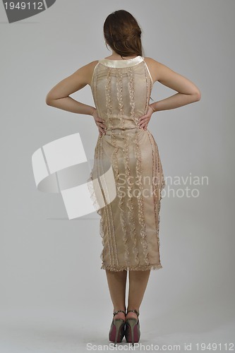 Image of elegant woman in fashionable dress posing in the studio