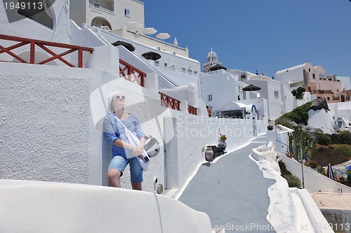 Image of Greek woman on the streets of Oia, Santorini, Greece