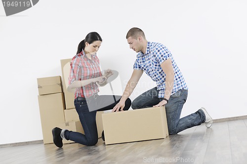 Image of Young couple moving in new home