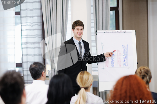Image of Young  business man giving a presentation on conference