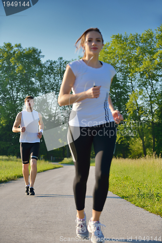 Image of Young couple jogging at morning
