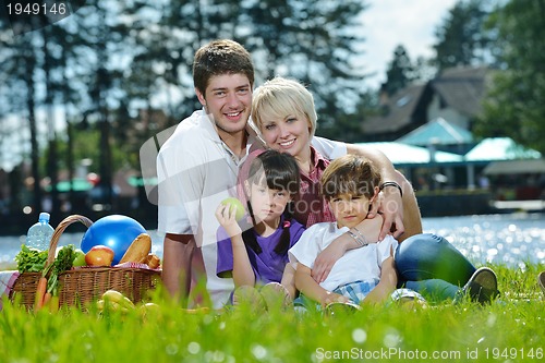 Image of Happy family playing together in a picnic outdoors