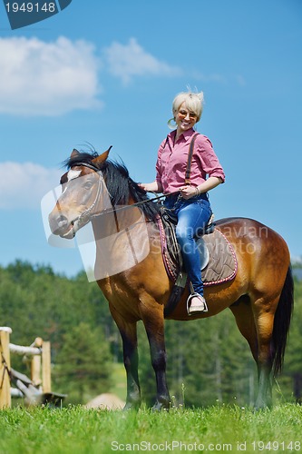 Image of happy woman  ride  horse