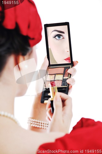 Image of beautiful young woman applying makeup