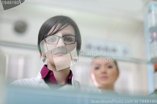 Image of pharmacist chemist woman standing in pharmacy drugstore