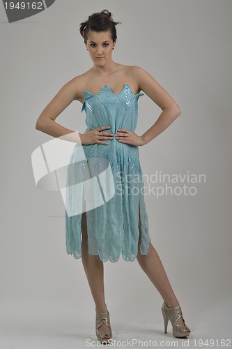 Image of elegant woman in fashionable dress posing in the studio