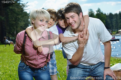 Image of happy young family have fun outdoors