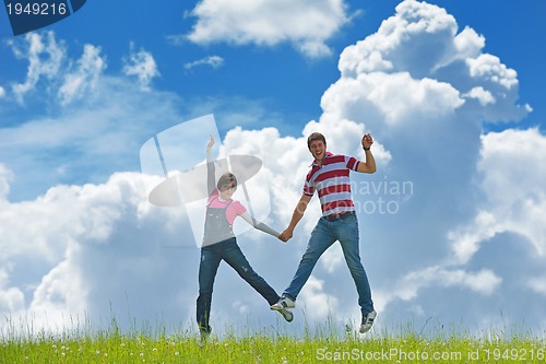 Image of Portrait of romantic young couple smiling together outdoor