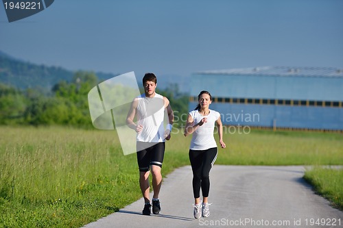 Image of Young couple jogging