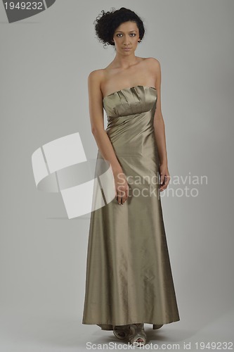 Image of elegant woman in fashionable dress posing in the studio