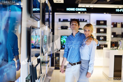 Image of Young couple in consumer electronics store