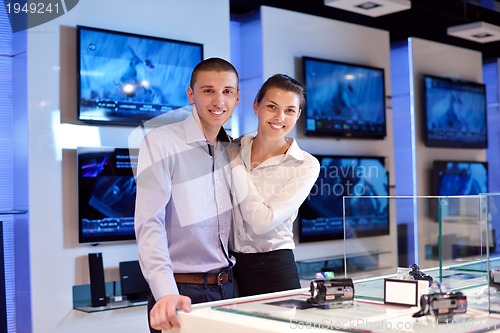 Image of Young couple in consumer electronics store
