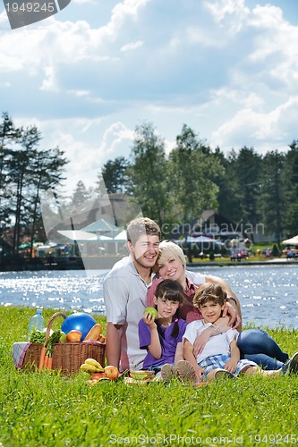 Image of Happy family playing together in a picnic outdoors