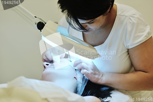 Image of woman with facial mask in cosmetic studio