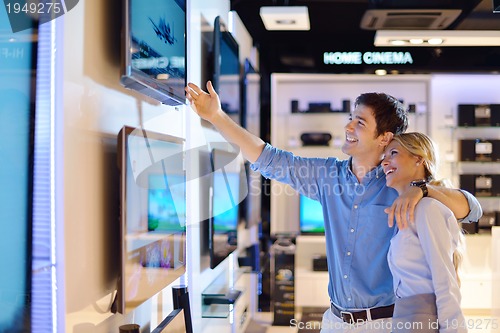 Image of Young couple in consumer electronics store