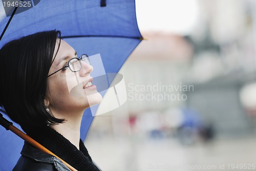 Image of woman on street with umbrella