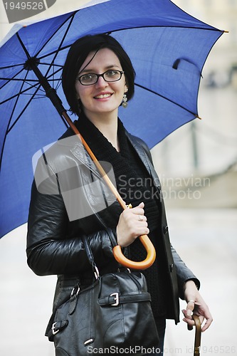 Image of woman on street with umbrella