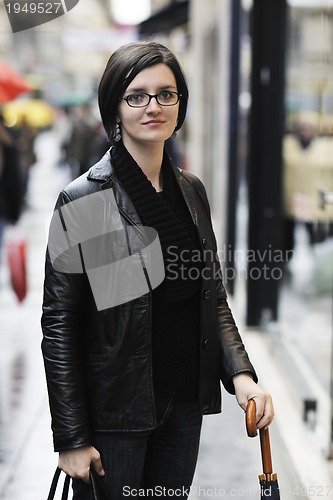 Image of woman on street with umbrella