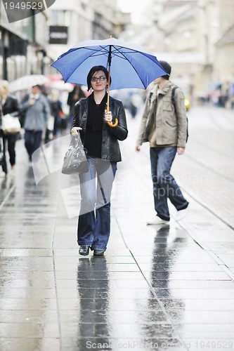 Image of woman on street with umbrella