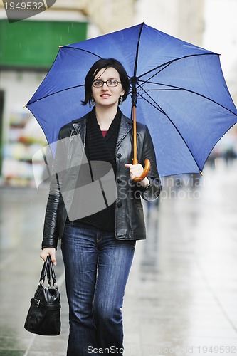 Image of woman on street with umbrella