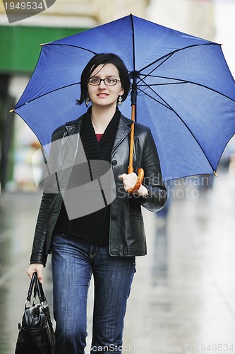 Image of woman on street with umbrella