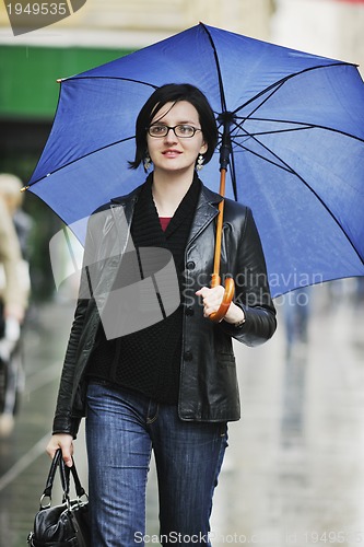 Image of woman on street with umbrella